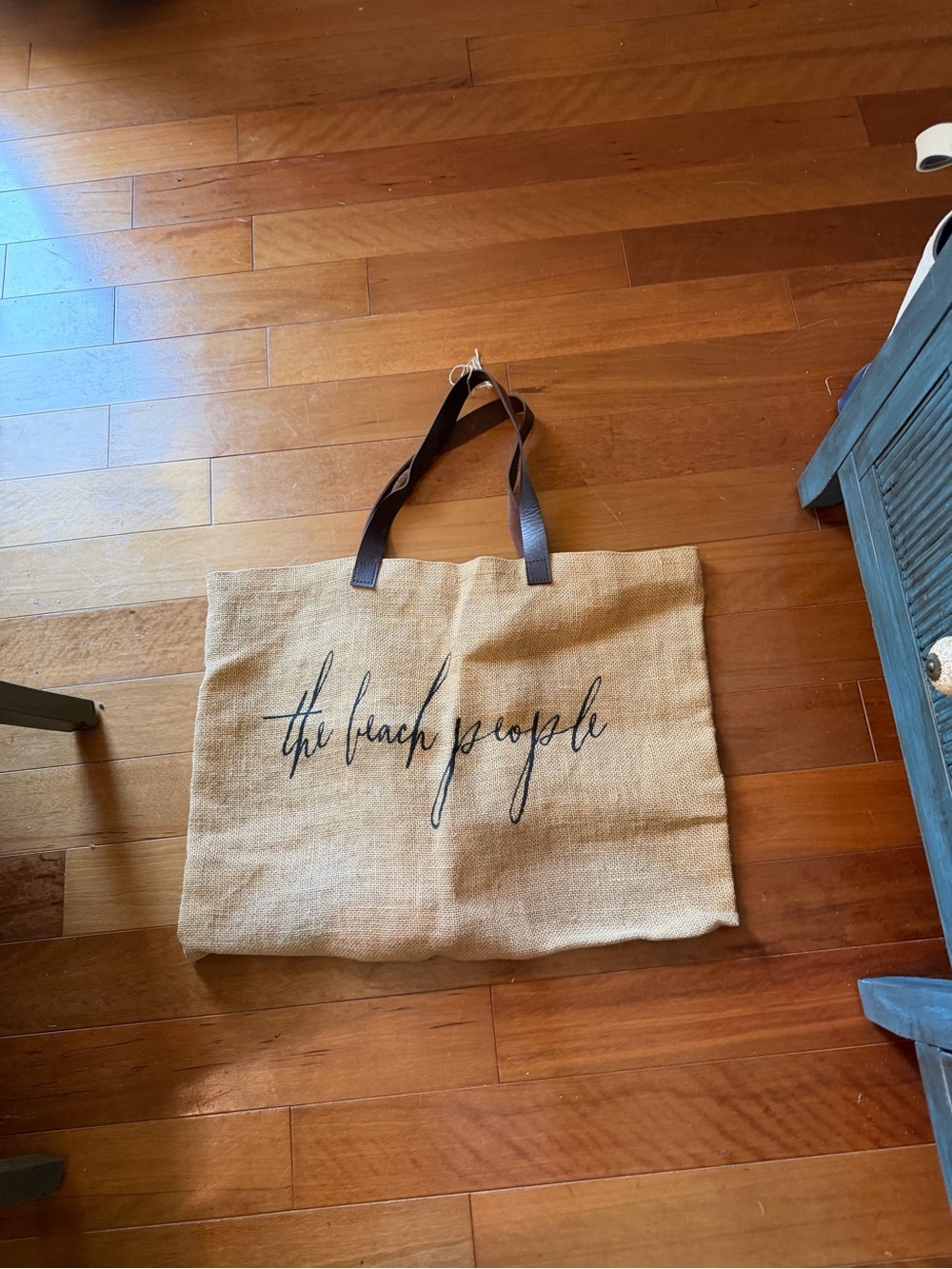 "The Beach People" Original Jute Bag, featuring distinctive dark brown leather
